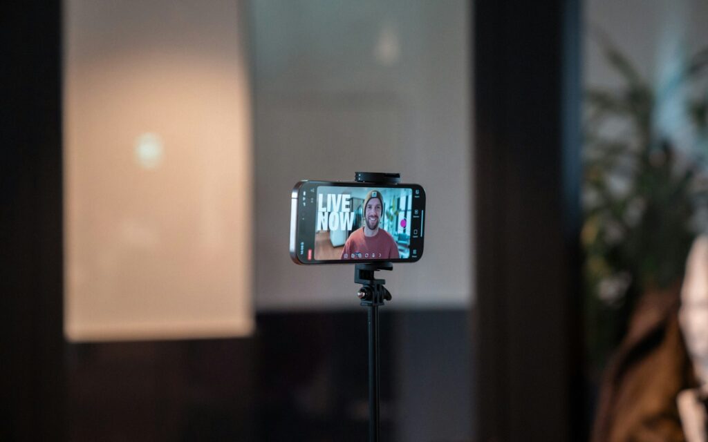 Smartphone su treppiede che registra un creator durante un video